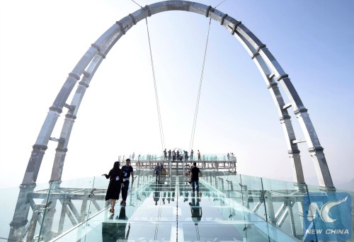 Walk the plank of the glass ledge.