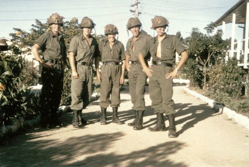 Enoggera, Queensland 1966 Members of 8 platoon, C Company, 6th Battalion, Royal Australian Regiment, in the battalion lines at Enoggera, Queensland, prior to deployment to Vietnam in May 1966. From left: 2781803 Private Rodney Cox of Ganmain, NSW; 2781794 Private Gordon Stafford of Gunnedah, NSW; 2781823 Private Neil (Pop) Baker of Newcastle, NSW; 2781790 Private Mark (Scrub) Minell of Moree, NSW; 2781809 Private Graham Irvine of Coolamon, NSW. All five men were called up in the first intake of national service in July 1965. Note the protective steel helmets with camouflage netting, usually worn by Australian infantry on operations in areas known to have been mined by the enemy. 