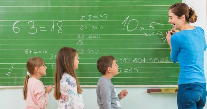 video of little boy doing math homework