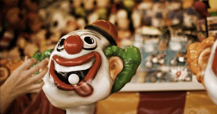 A ball is placed in the mouth of a crazy laughing clown in the carnival area during the Sydney Royal Easter Show. Photo: Mark Colbe/Getty Images