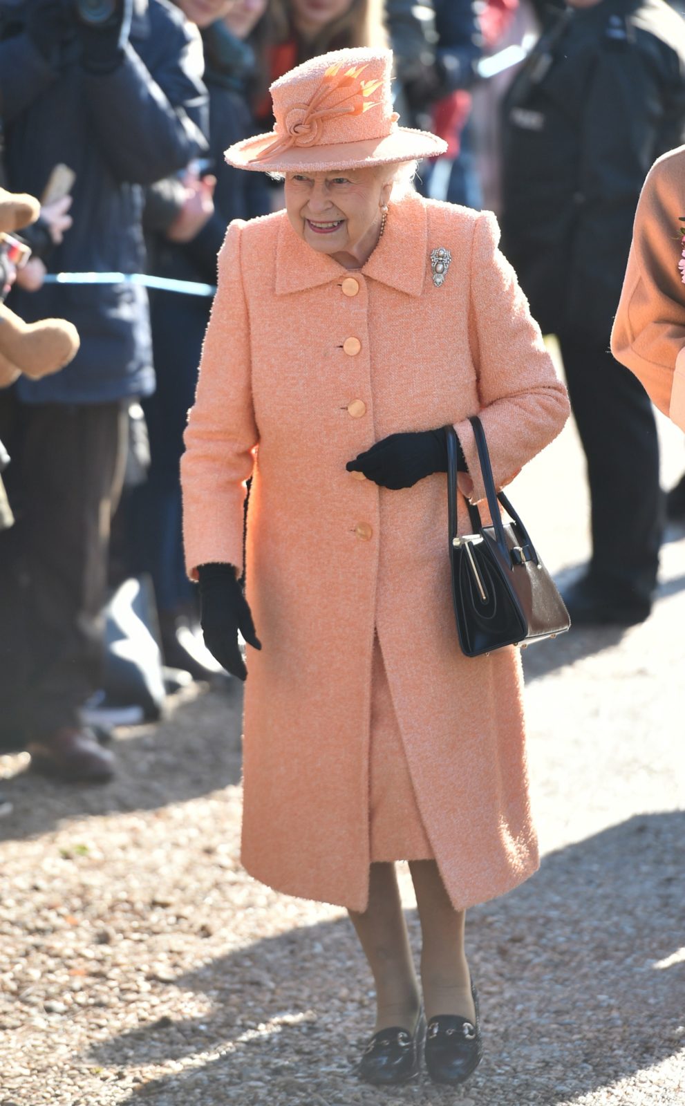 Queen Elizabeth stepped out in a pretty peach ensemble to attend Sunday church. Source: Getty