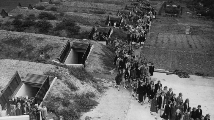 Children emerge from air raid shelters after participating in the drills during World War II. Source: Getty Images