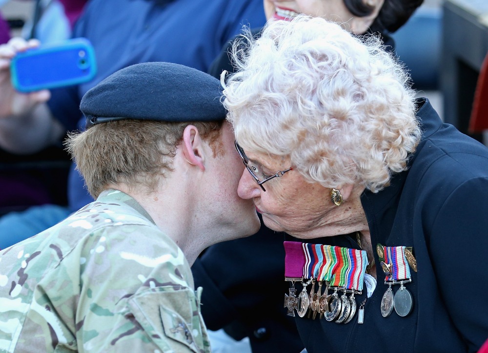 Prince Harry meets Daphne Dunne (wearing her husbands Victoria Cross) for the first time during a walkabout outside the Sydney Opera House on May 7, 2015 in Sydney, Australia. Source: Getty.