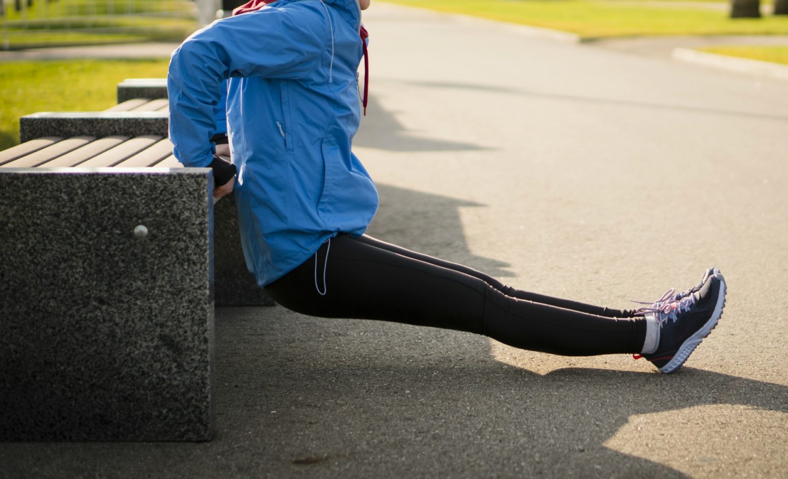 Older lady using the bench dip exercise to reduce her bingo wings.