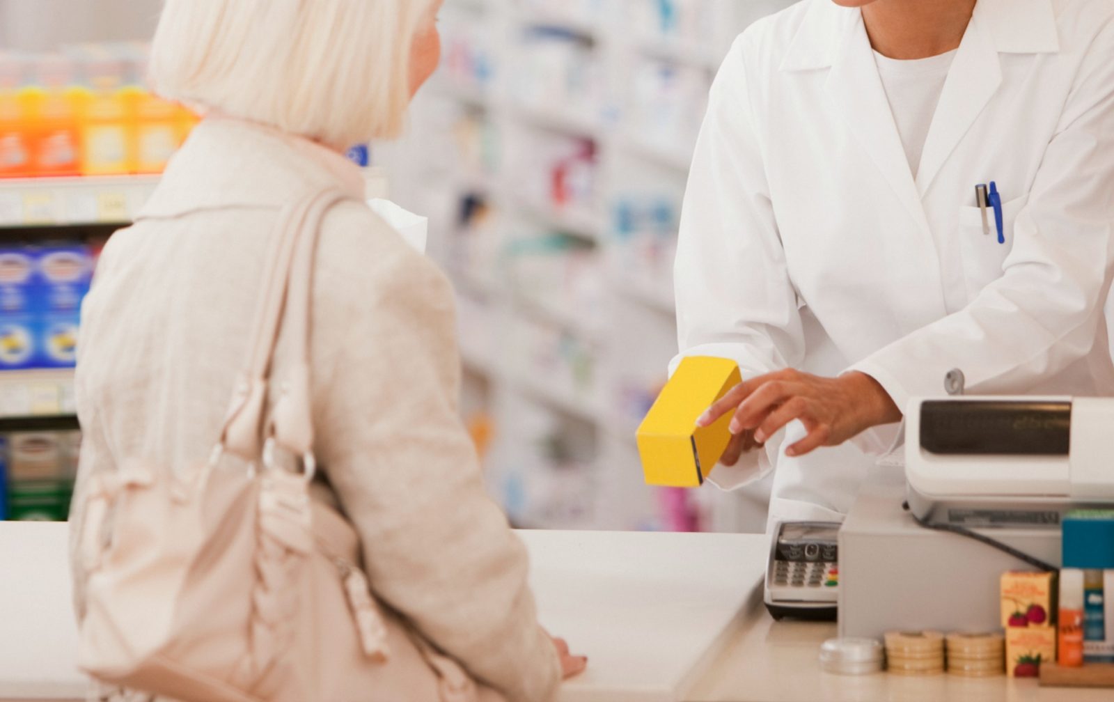 old lady buying hair loss products at the chemist