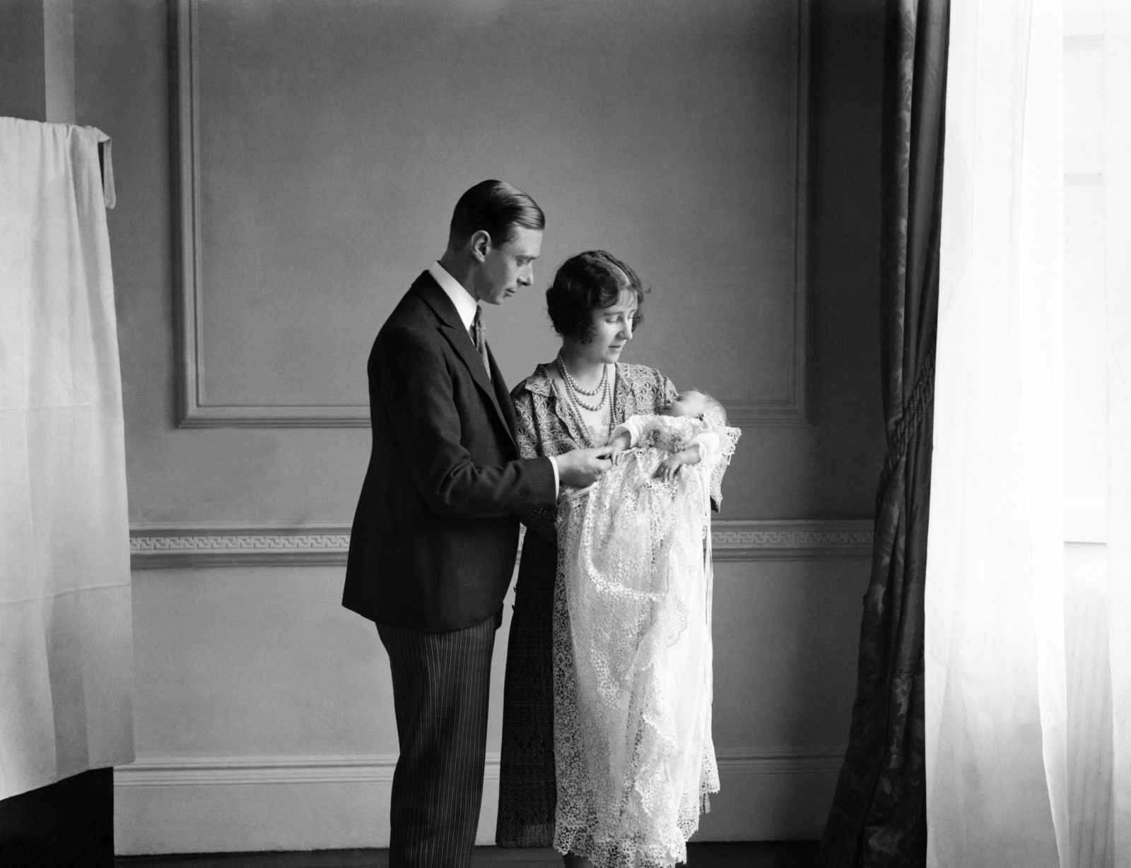 Baby Elizabeth, who would go on to become the Queen, is held by her parents in 1926. Source: Getty.