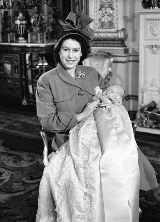 Prince Charles is held by his mother, the Queen, in 1948 at his christening. Source: Getty.