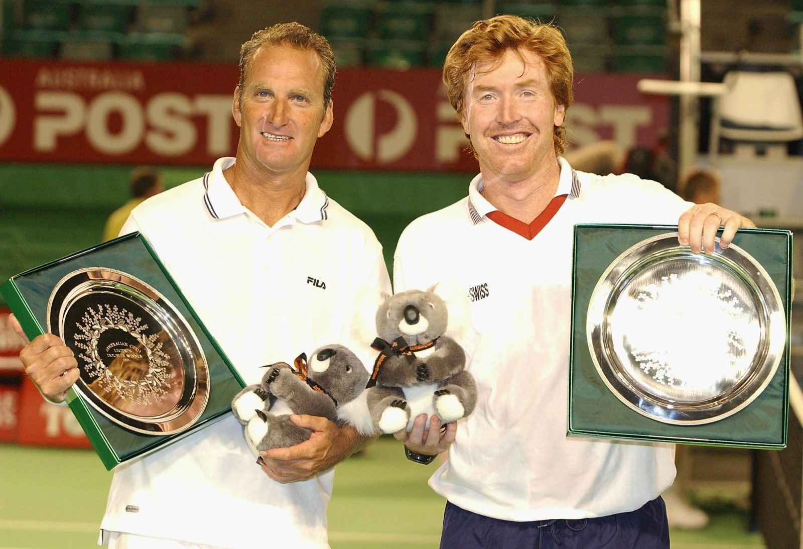 Peter McNamara and Mark Woodforde celebrate their victory over John Lloyd of Great Britain and John McEnroe of the USA. Source: Getty.