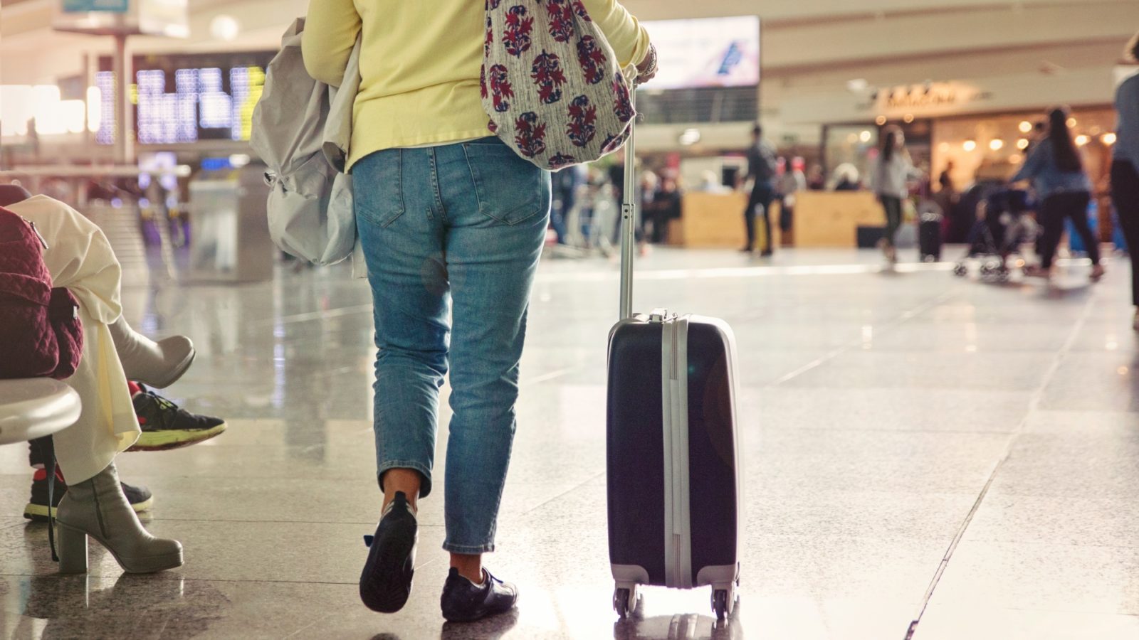 Woman walking through airport with luggage