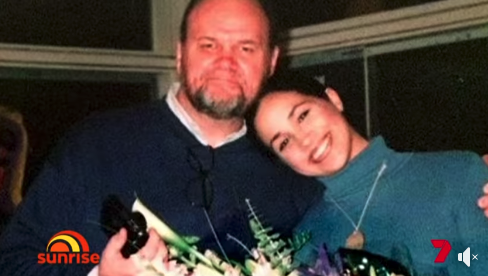 screenshot form sunrise showing an old picture of Meghan resting her head on her father Thomas Markle Sr's shoulder.