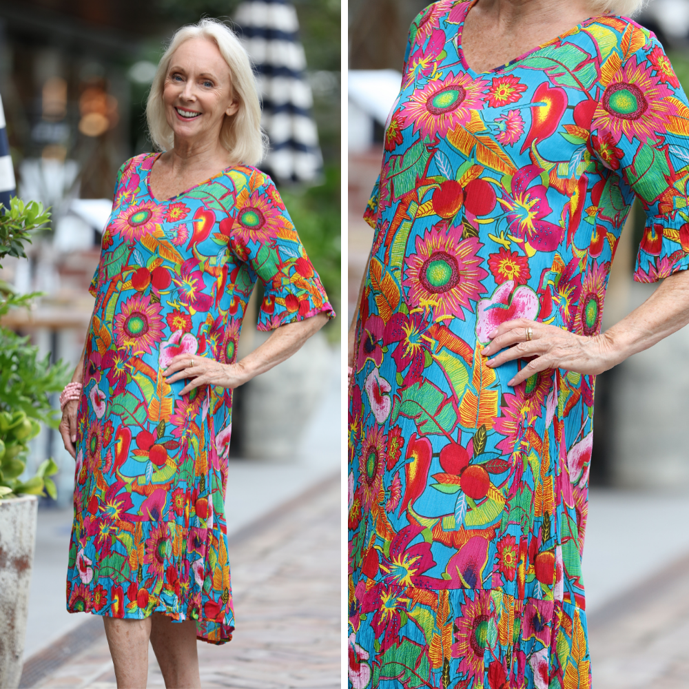 woman wearing bold pattern floral dress with 3/4 sleeve and knee-length
