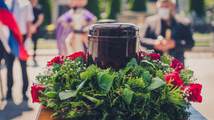 Funerary urn with ashes of dead and flowers at funeral. Image: Getty
