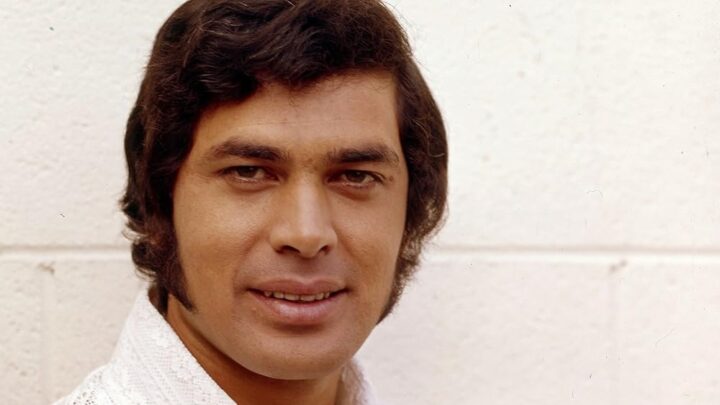 Young Engelbert Humperdinck with dark hair and sideburns in an early-career portrait.